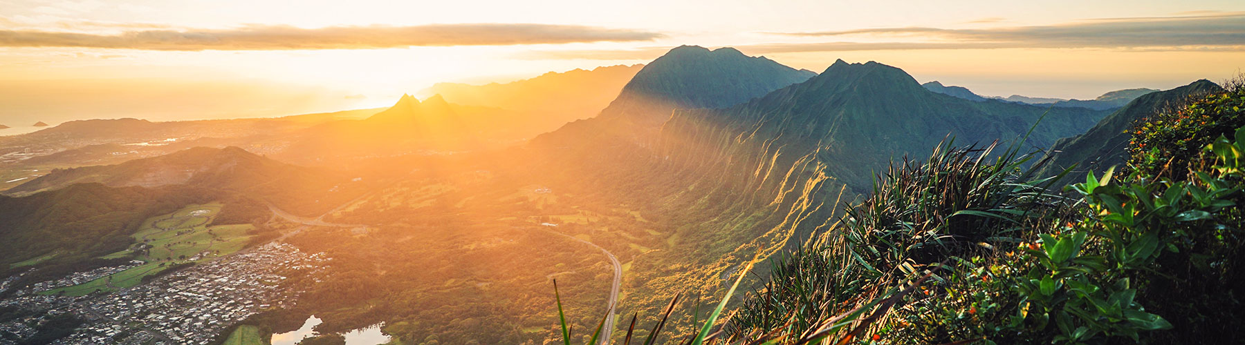 the sun is setting over a mountain range.