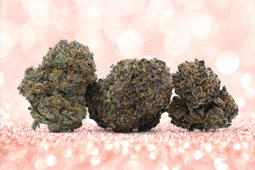 three marijuana buds sitting on top of a pink glitter background.