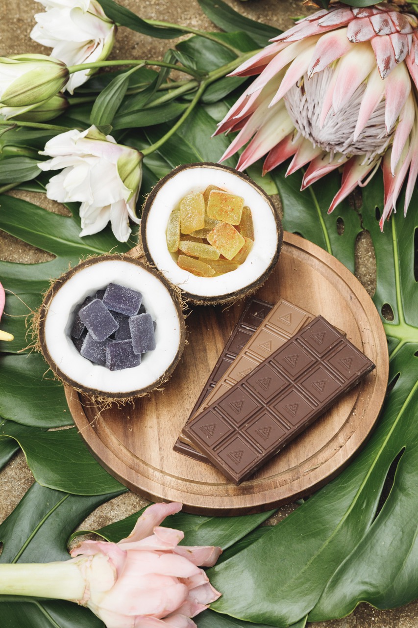 A plate with medicated cannabis-infused chocolate and dried flowers.