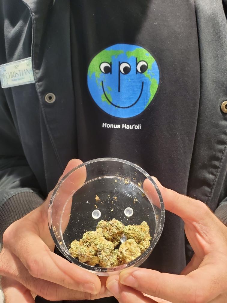 A person holding a bowl of Apple Mints marijuana cannabis strain